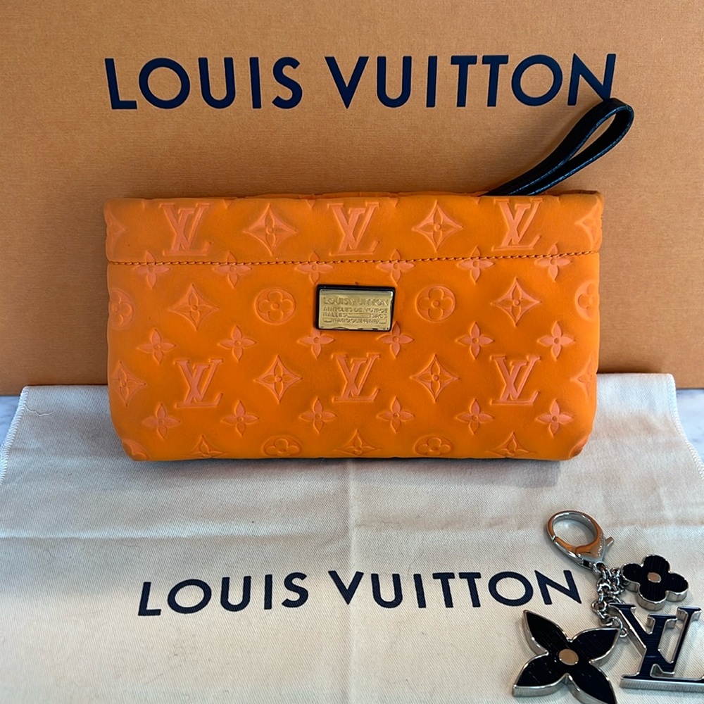 Louis Vuitton scuba pouch wristlet  🍊
Listing is for orange clutch only 🍊